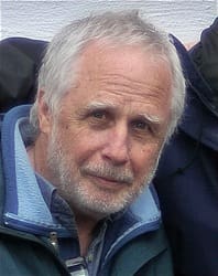 Elderly man with grey hair and beard.