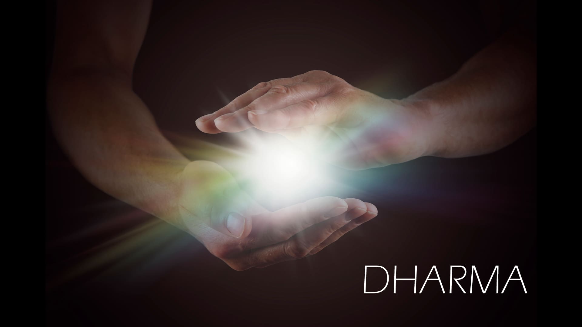 Hands holding a glowing orb with rainbow light.