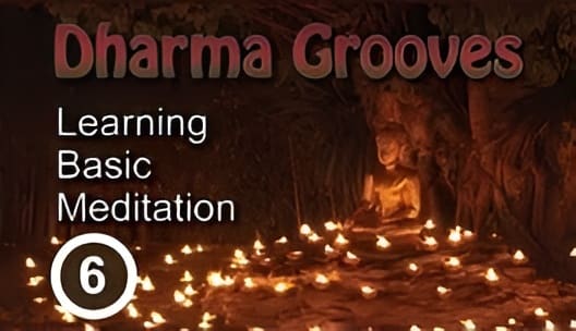 Buddha statue surrounded by candles.