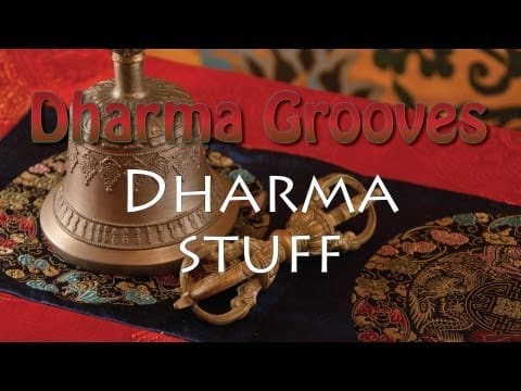 Buddhist bell and vajra on colorful fabric.