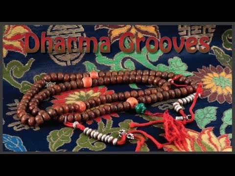 Beaded necklace on colorful floral fabric.