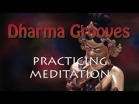 Statue with "Dharma Grooves Practicing Meditation" text.