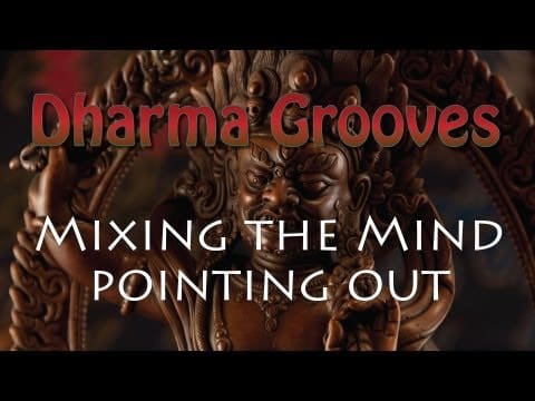 Dharma Grooves statue with text overlay.