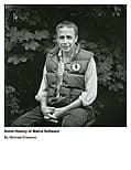 Man sitting outdoors wearing a vest.