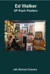 Man sitting among framed rock posters and artwork